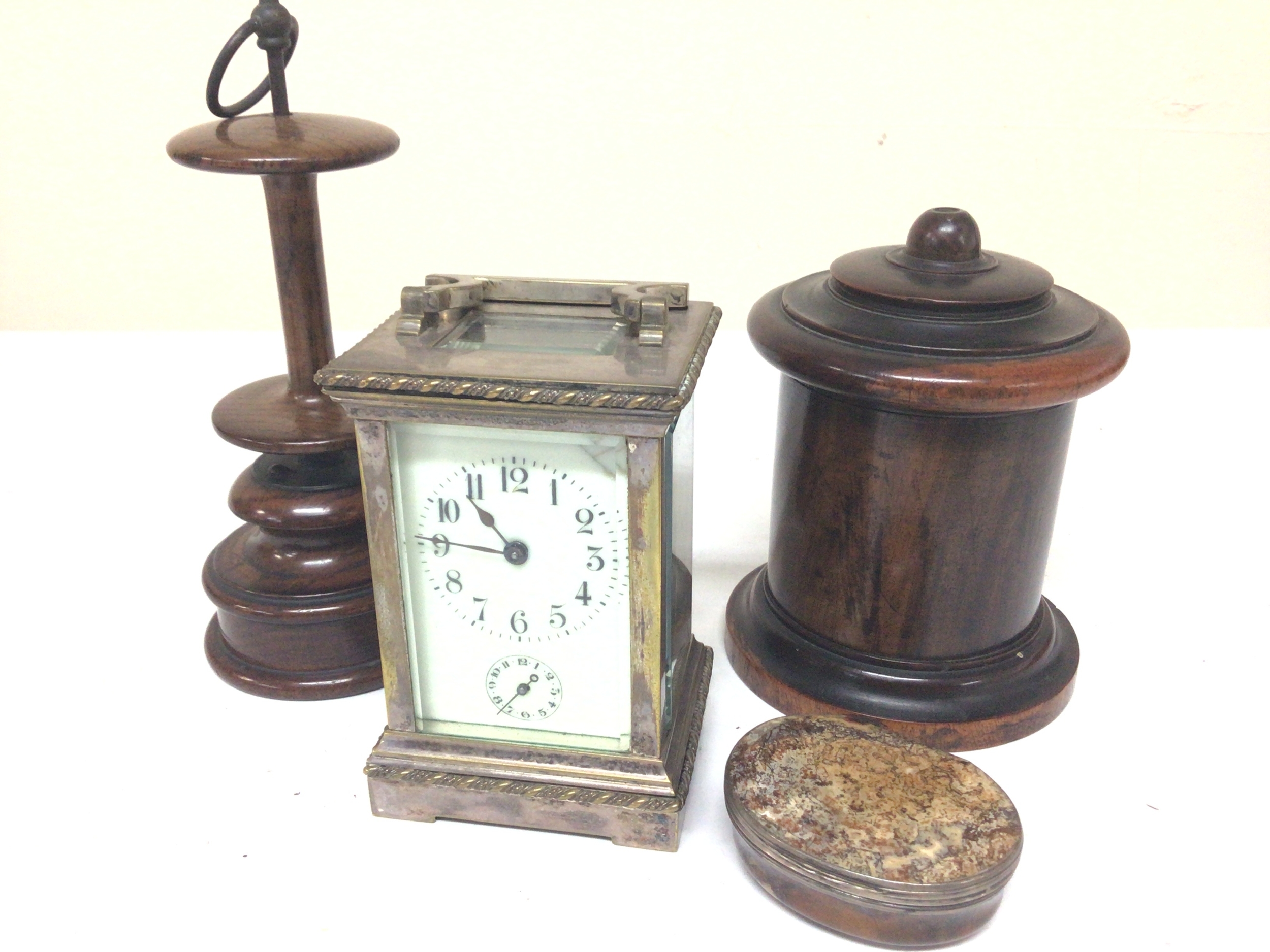  A lignum Vitae wood 19th century string barrel a polished agate snuff box (repaired) a treen bobbin and a silvered carriage clock (not seen working) 