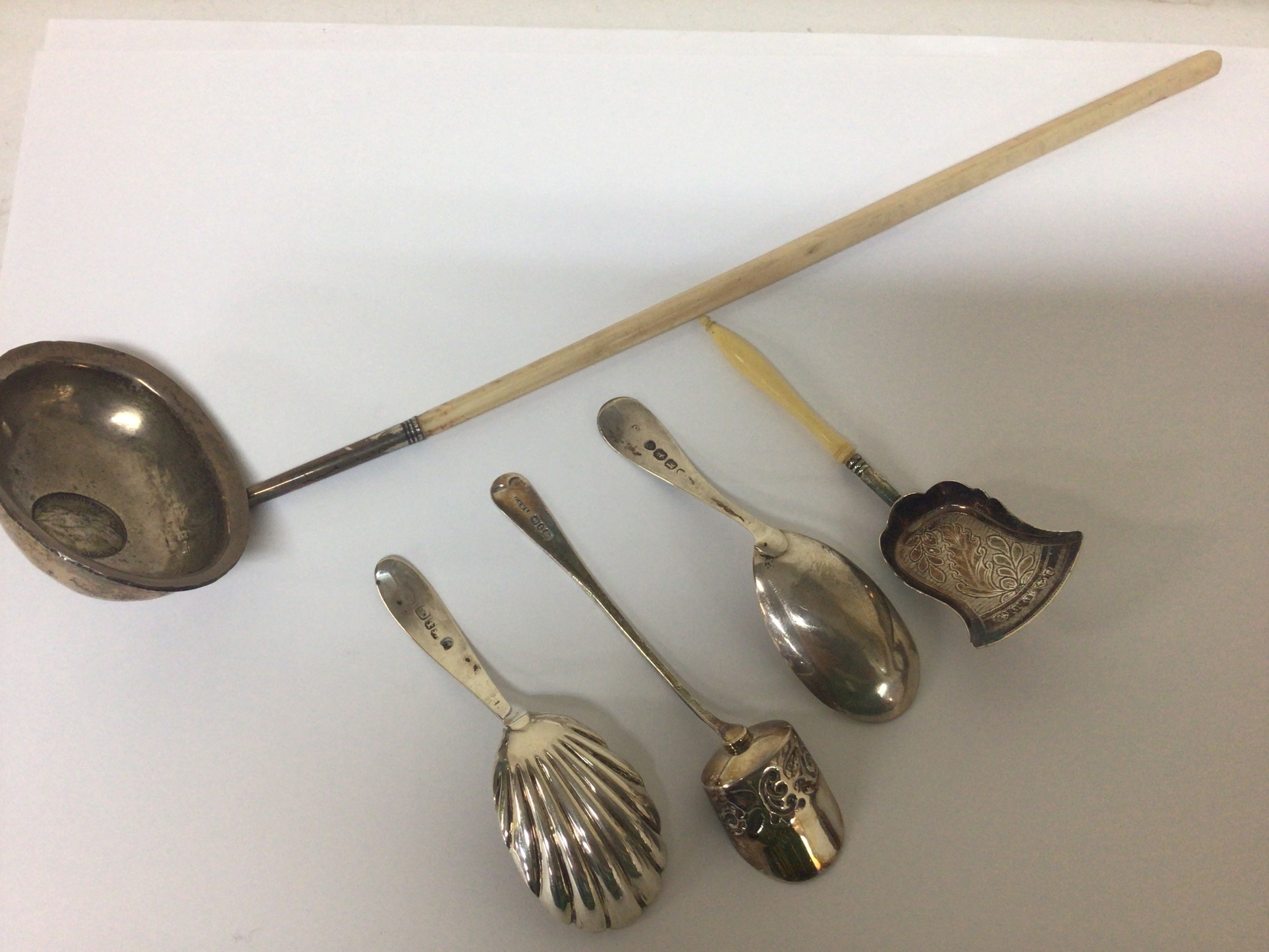  A George III silver toddy ladle and four silver caddy spoons. 