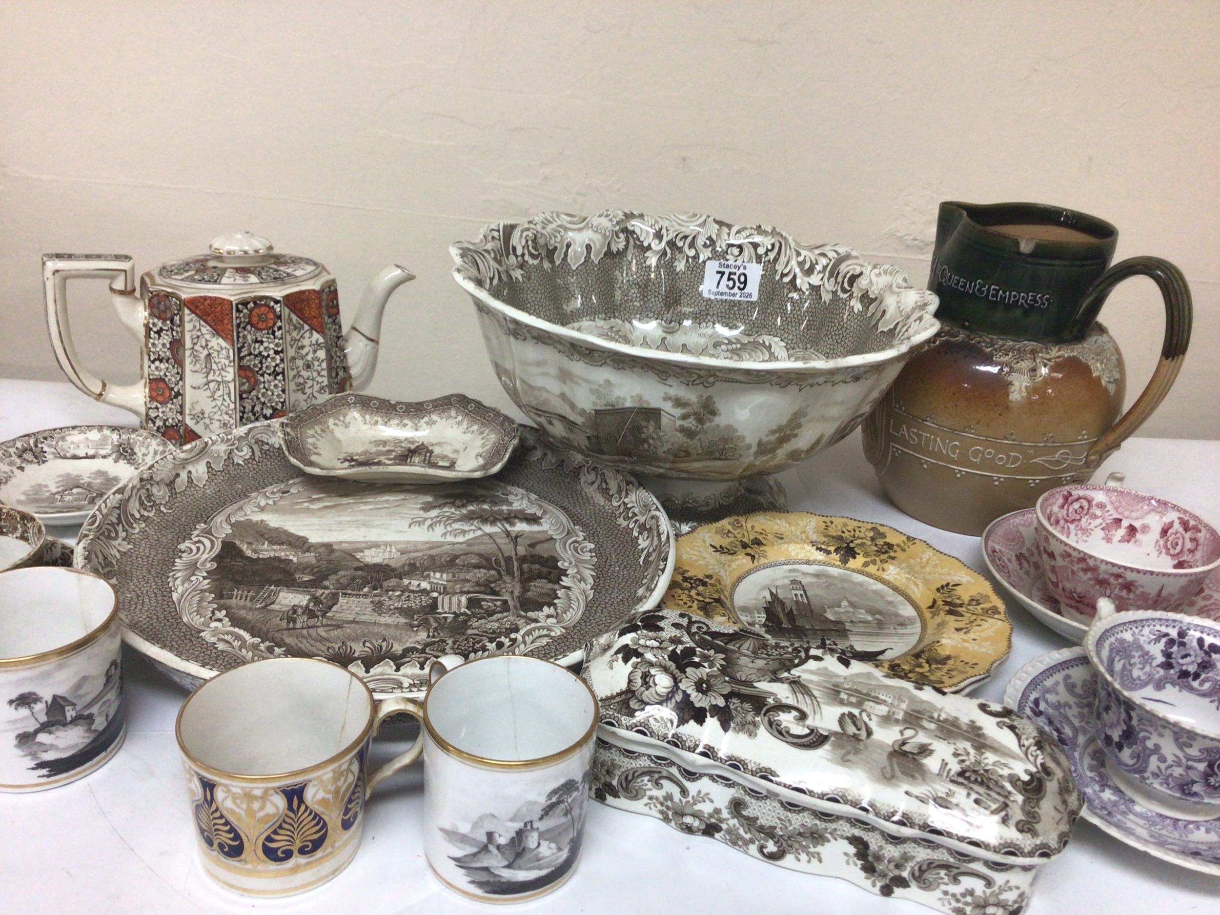  A collection of Victorian transfer decorated ceramics a Doulton commemorative stoneware jug cups and saucers of the early 19th century. 