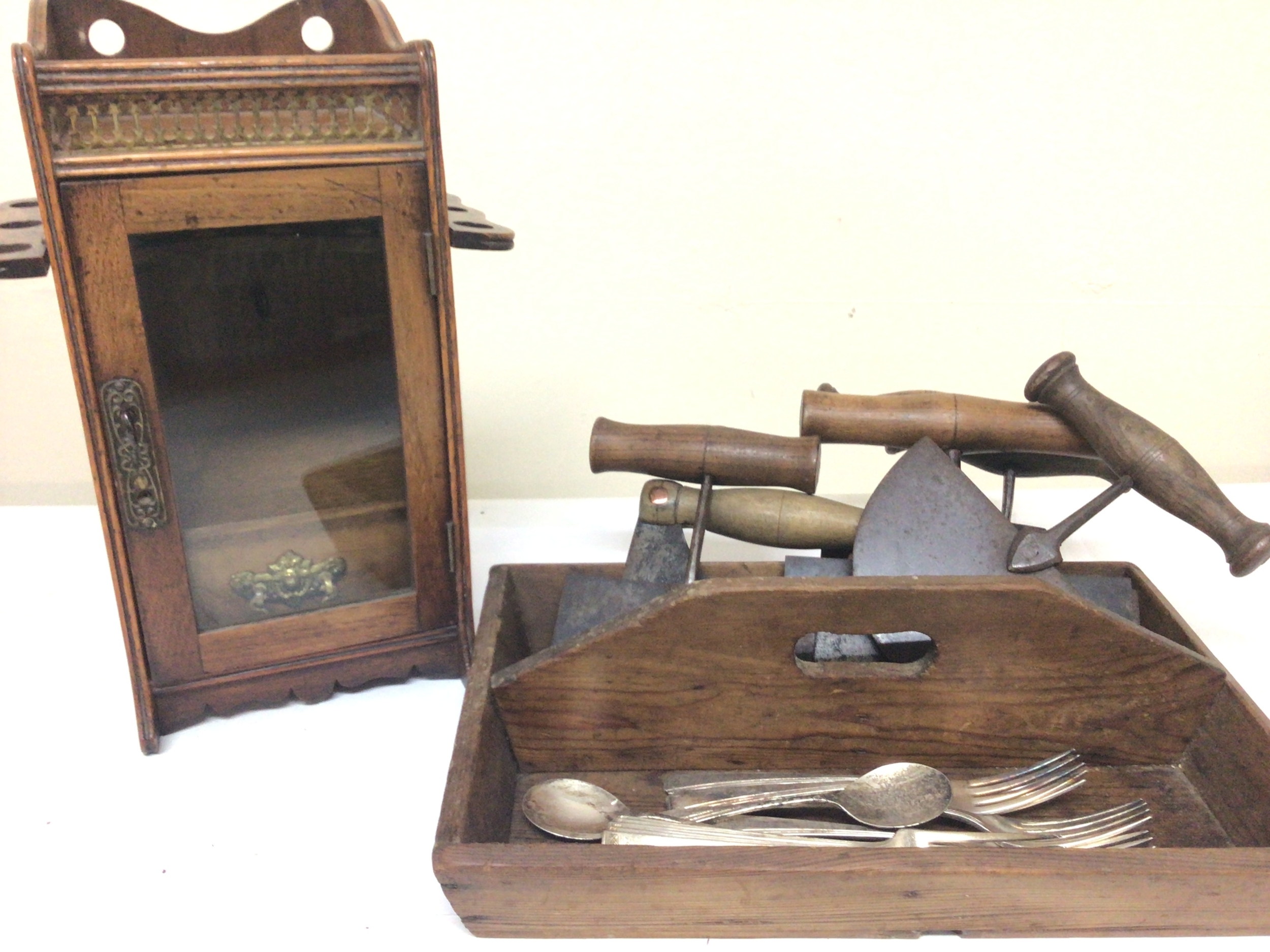 A Victorian tobacco cabinet with folding pipe rack a pine cutlery tray and antique steel and wood chopping implements. 