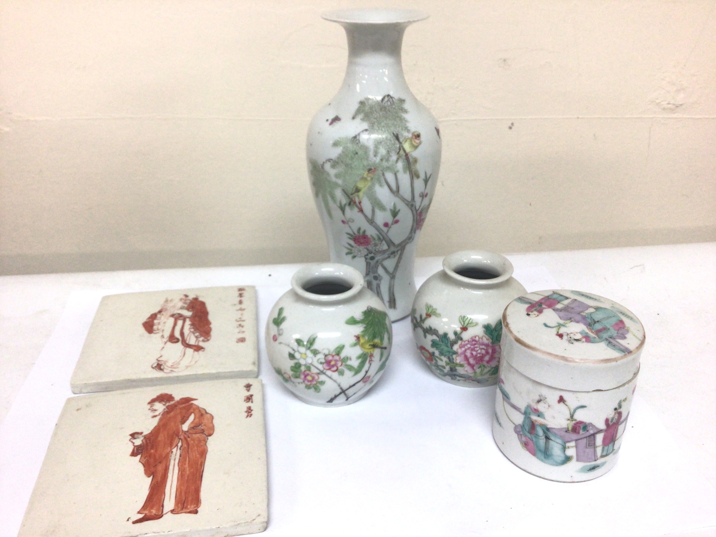  A Chinese late republic porcelain vase six caricature marks to the base decorated with birds in trees a smaller pair of vases two tiles and a late 19th century jar and cover. (6) 