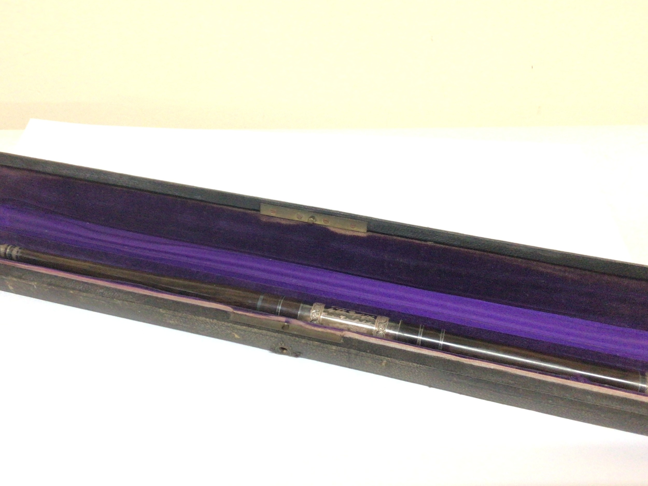 A quality music conductors baton a polished hardwood with white metal mounts with inscription. In a fitted case.