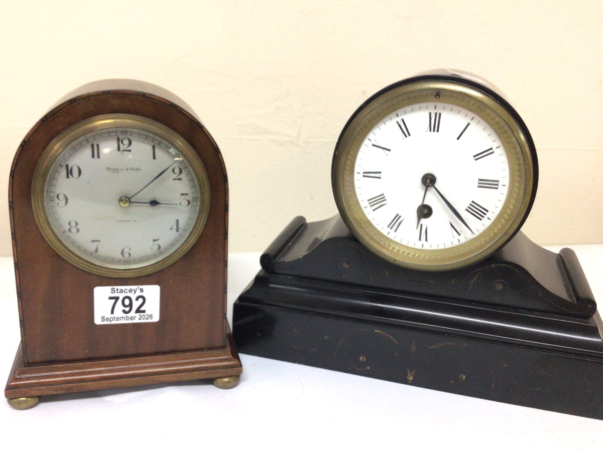 A Mappin & Webb mahogany cased Mantel clock and a black slate clock with an enamel dial brass French movement and with pendulum. Maximum height 21cm (2)
