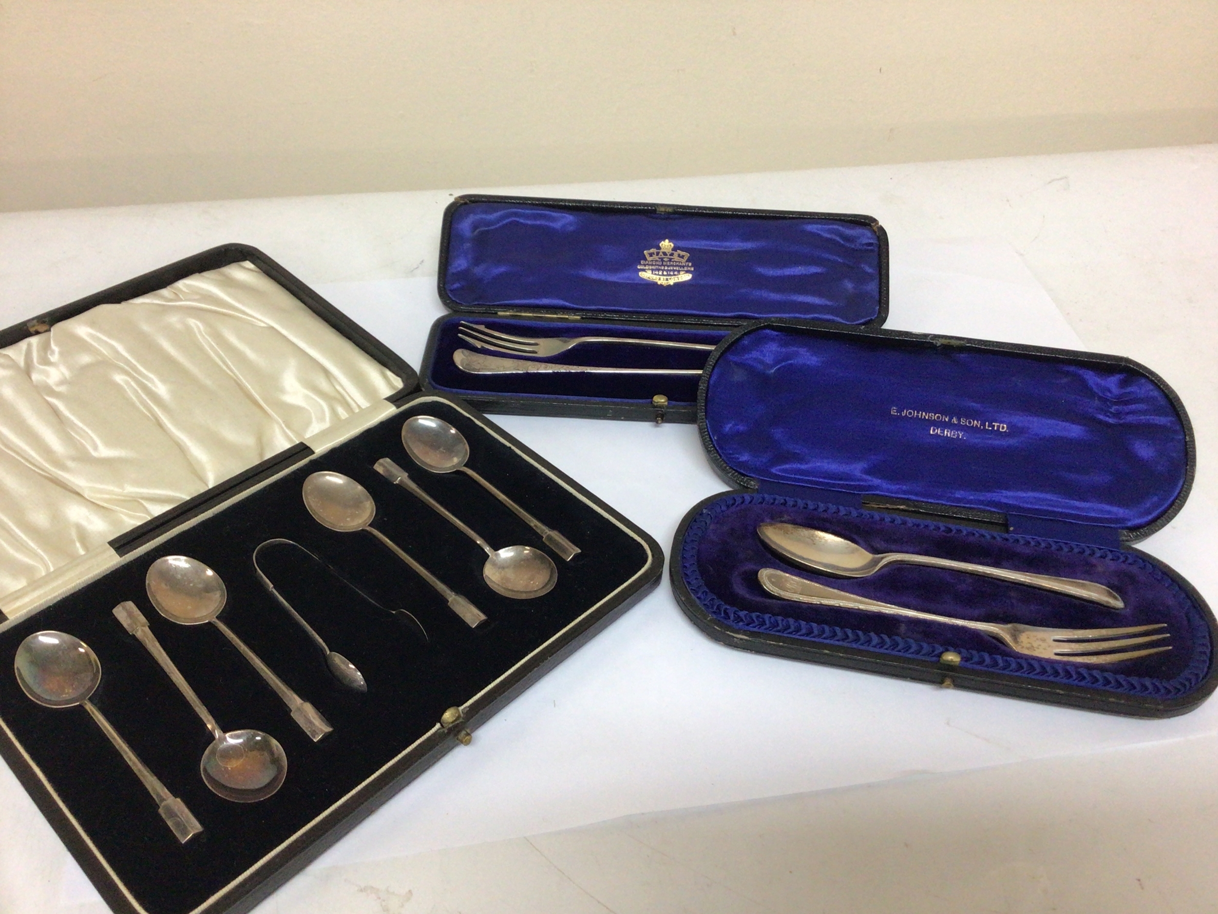  A cased set of silver tea spoons two silver pickle folks and a silver spoon and folk al, in presentation cases. (3) 