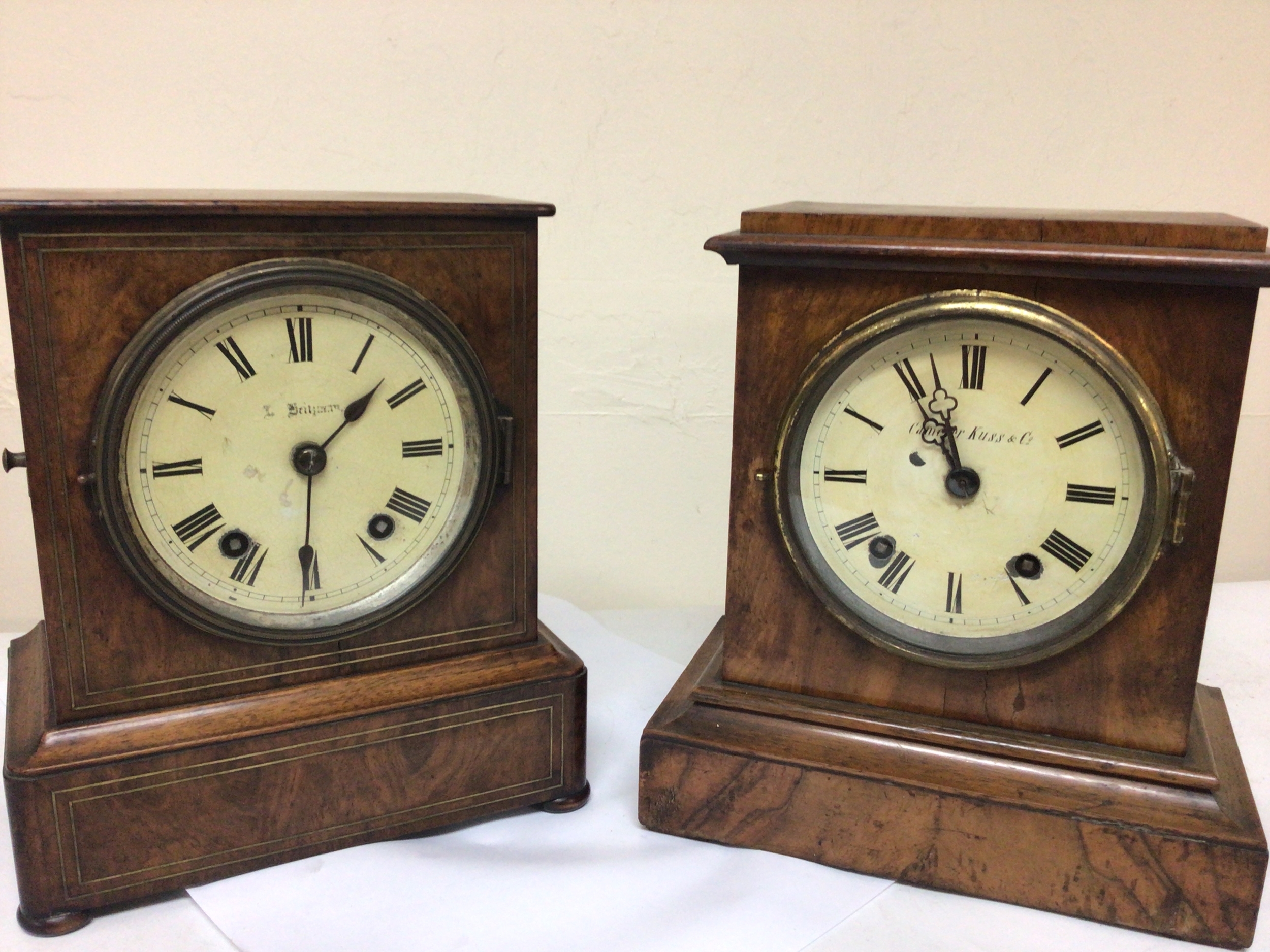  Two Victorian walnut cased mantel clocks maker Camerer Cuss & Co and one other both with brass movements striking on gongs with pendulum attached. Seen working height 27cm (2) 