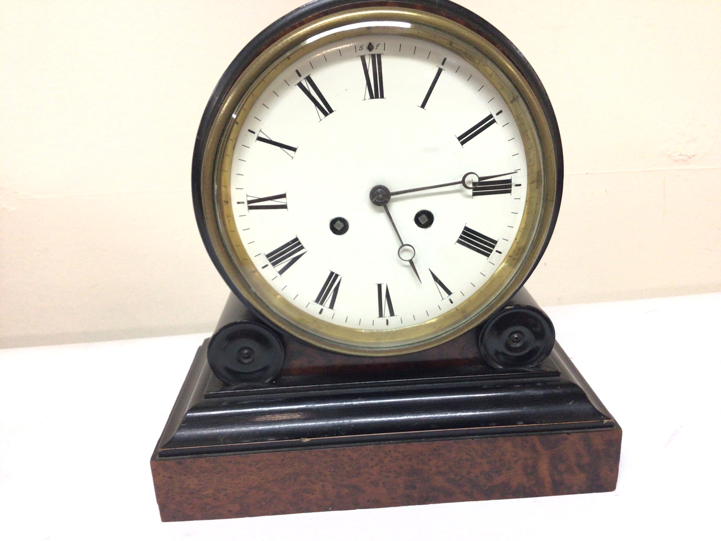  A Nice quality Victorian mantel clock with a white enamel dial in a walnut and ebony case with a brass French movement striking on a bell with pendulum attached. Hight 27cm. 