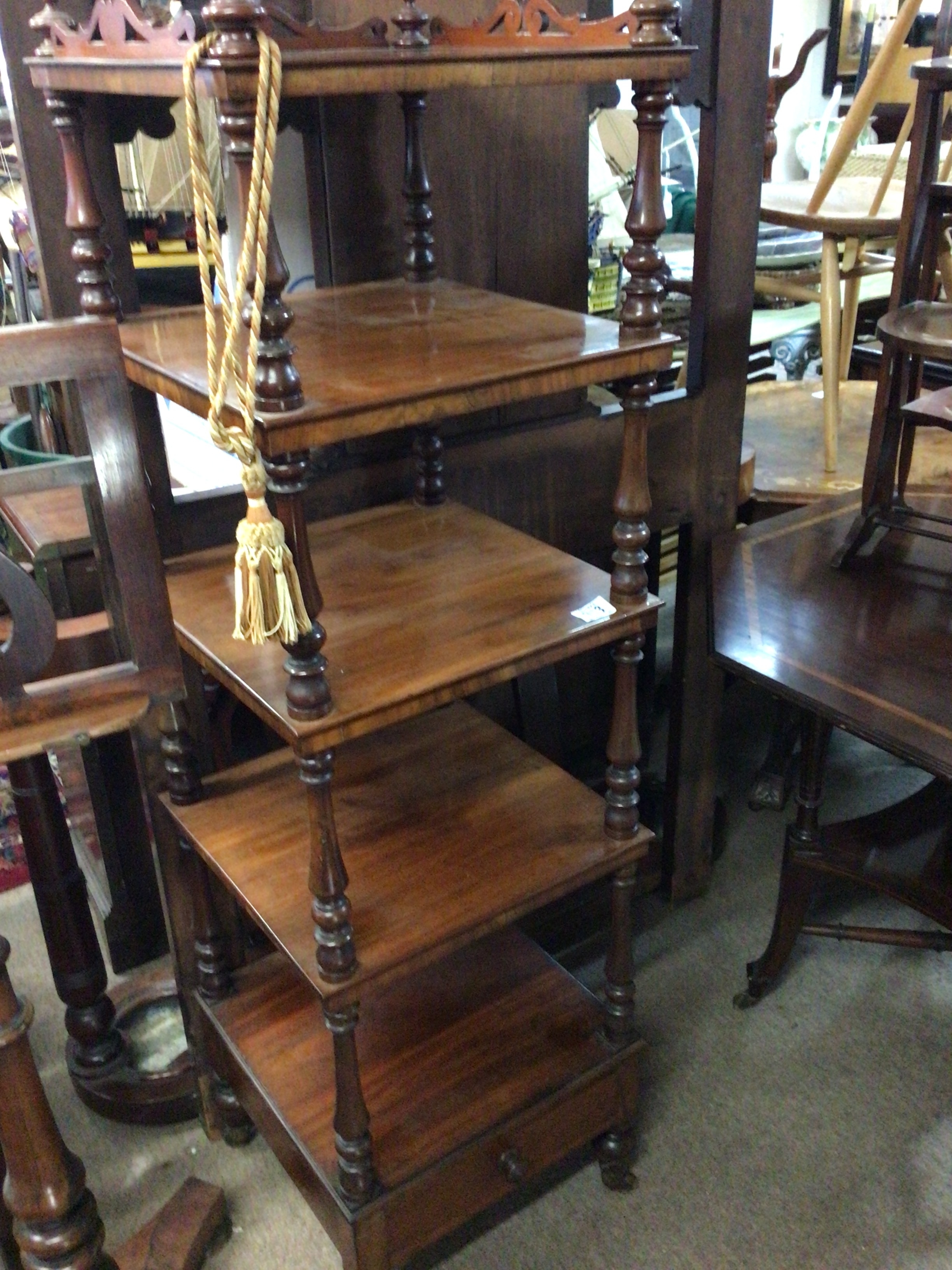  A quality Victorian walnut whatnot stand with turned supports above a drawer.