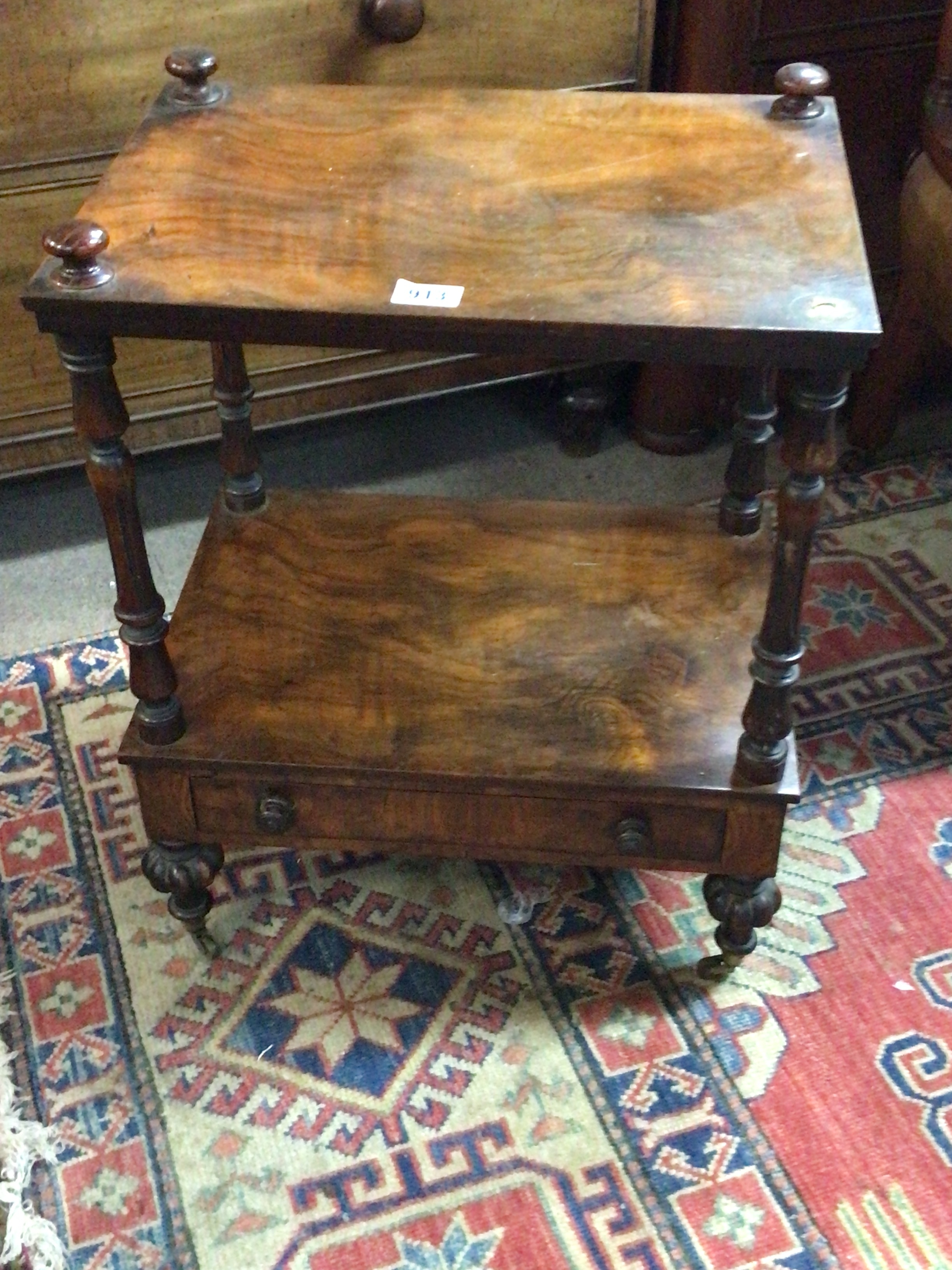  A Victorian walnut two tier stand with turned supports. 