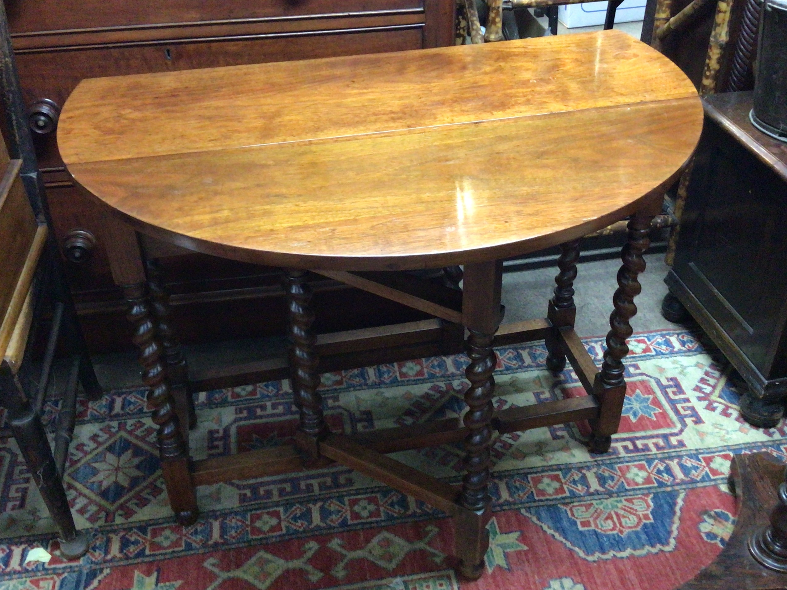 A polished oak and mahogany drop leaf table with a single drawer and four chairs with solid seats