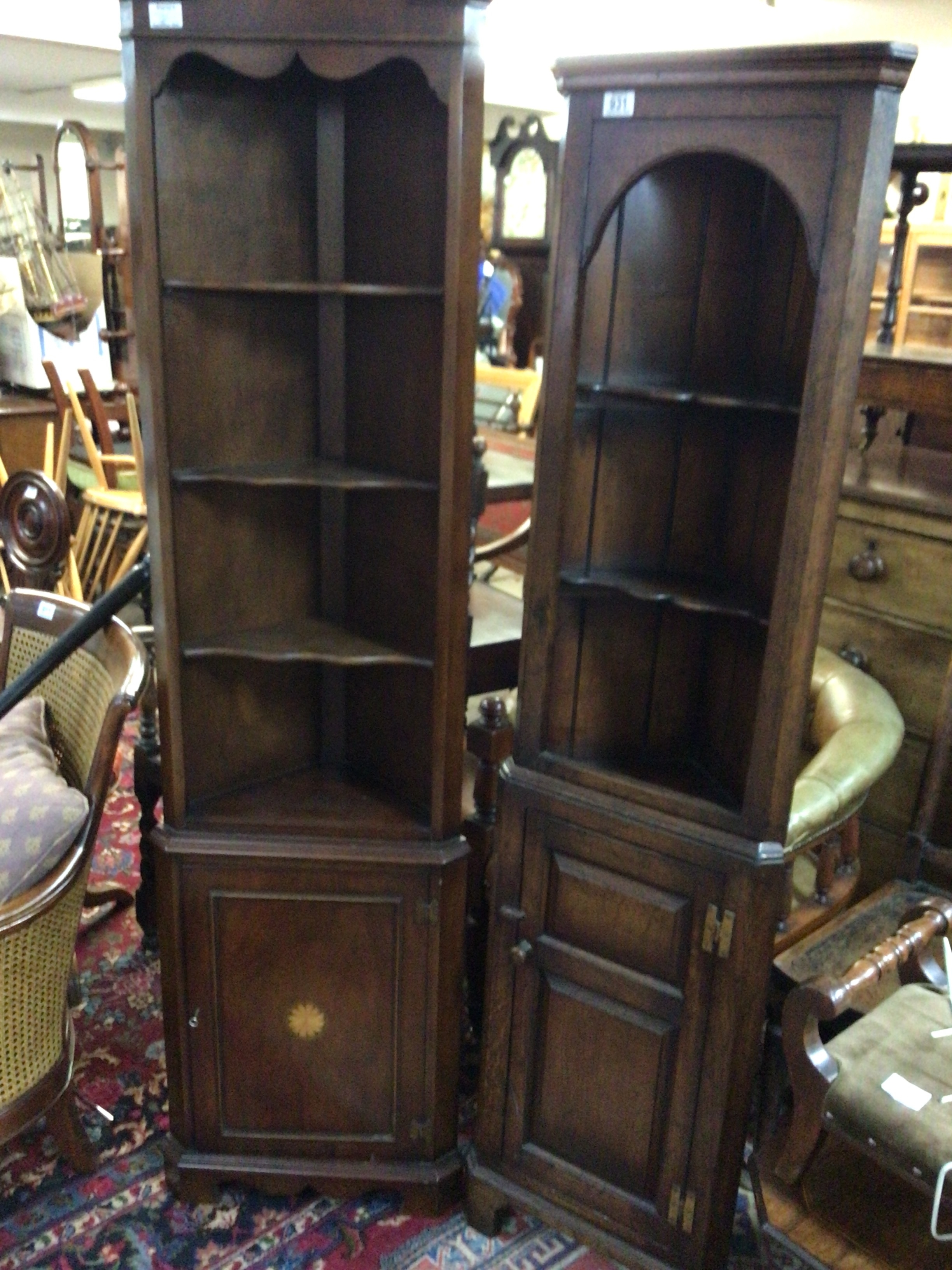  A petite oak corner unit with open shelves above a panel cupboard and a Mahogany corner unit. (2) 