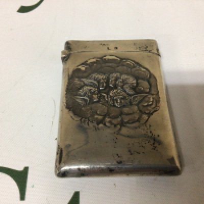 A Silver card Case decorated with winged cherubs amounts clouds. Birmingham hallmarks.