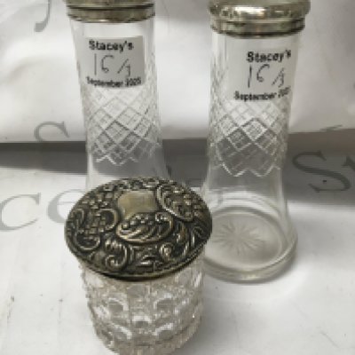A pair of silver rim glass vases and a tidy jar with silver lid .