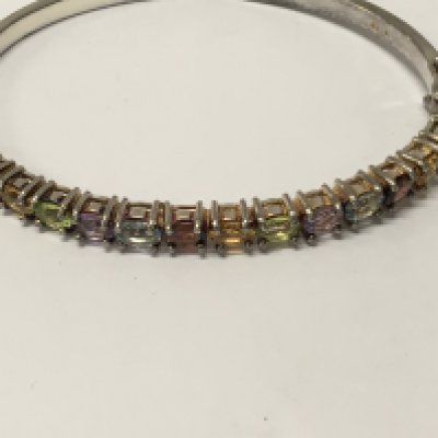 WITHDRAWN - A 9 ct gold bangle inset with multi gem stones .