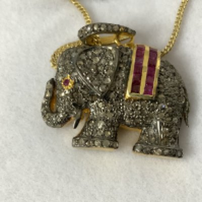 Silver gilt elephant pendant set with rubies and diamonds, on a gold plated silver chain, boxed. Rubies 0.60ct. Diamonds 1.38ct. Postage category A.