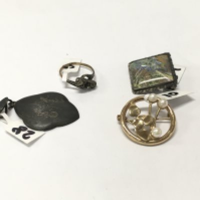 Two brooches and a silver ring and pendant.