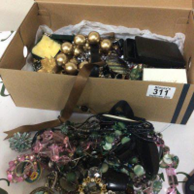 A box containing costume jewellery necklaces brooches watches.