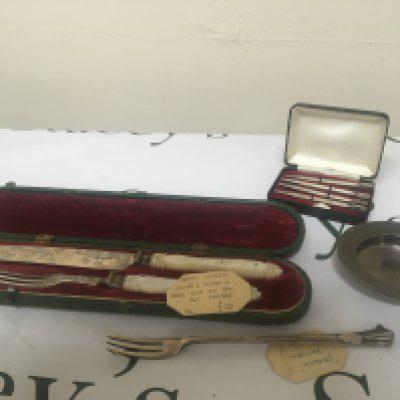 A Quality cased Victorian silver knife and folk with mother of pearl handles Sheffield hallmarks a pickle fork cased set of silver bridge pencils and a small silver dish. (4)
