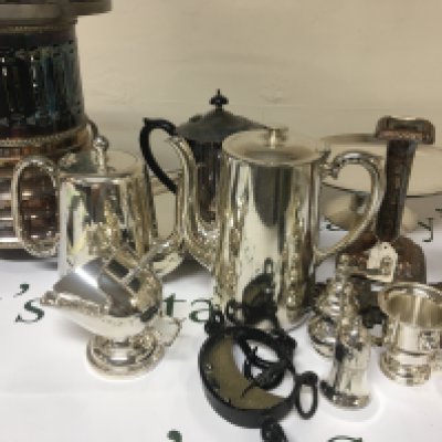 A box containing silver plate including a food warmer tea and coffee pots candle sticks and other ornaments including a vintage hanging scale