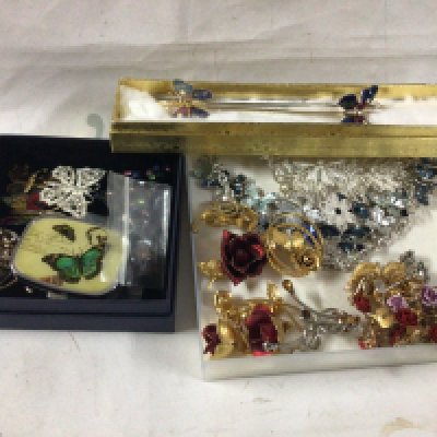 A collection of rose and butterfly costume jewellery.