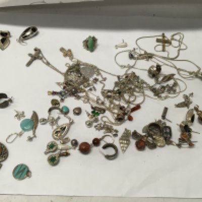 A collection of silver pendants and chains .