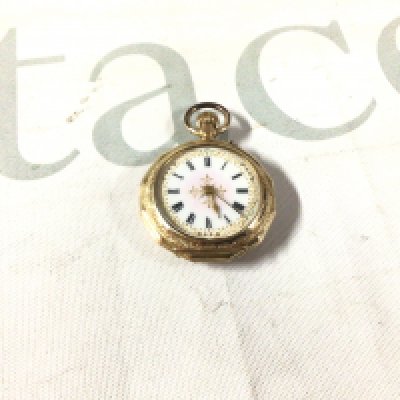 A 14k stamped fob watch with enamel decoration.