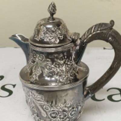 A small Victorian silver coffee or chocolate pot repousse chased with garlands simulated ribbon ties. Height 17cm weight 251g