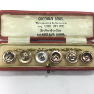 A boxed set of rose gold and mother of pearl antique dress studs. Shipping category A.