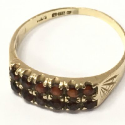 A 9ct gold ring set with garnets , 2.1g total weight. Postage category A