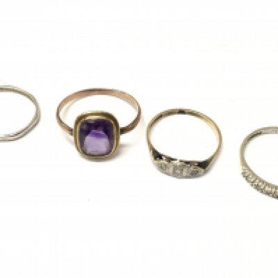 A Platinum ring (1.4g), unmarked ring set with purple gemstone, 9ct gold and platinum ring (1.1g), 9ct gold half eternity ring (1.1g)Postage category A