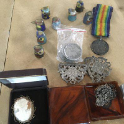 A small collection of costume jewellery coins First World War medals and thimbles .