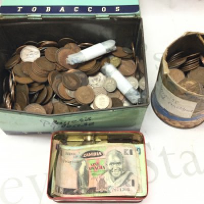A collection of British coins including pennies and world notes