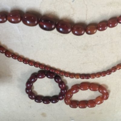 Two Amber bakelite bangles and necklace.