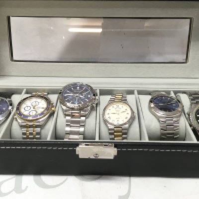 Six gents watches including Sekonda, Bulova, Seiko etc in a display case. seen working