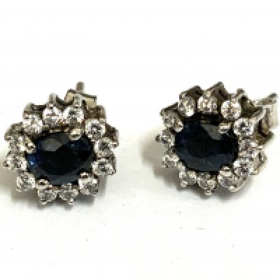 A pair of white gold sapphire and diamond cluster stud earrings.