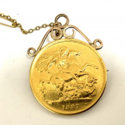 An 1887 Double Sovereign with soldered mount and pin/saftey chain. 17.8g (A)