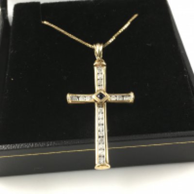 9ct white and yellow gold cross channel set with diamonds and a central sapphire on gold plated chain. Postage A