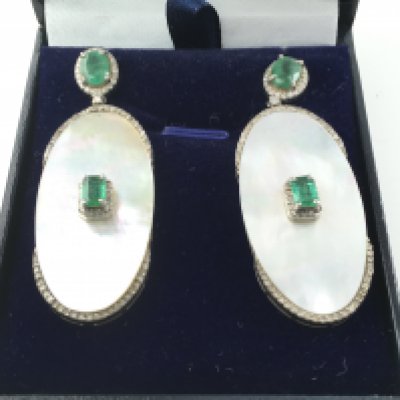 Pair of silver large drop earrings set with mother of pearl emeralds and diamonds. Mother of pearl 21.75ct emeralds 2.74ct and diamond 0.69ct.