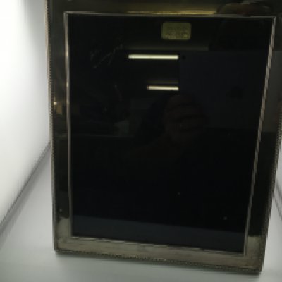 A silver hallmarked photo frame made by mappin and Webb. 25 by 30 cm