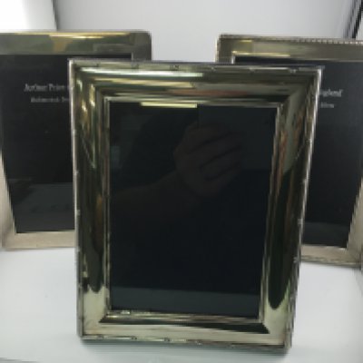 Three hallmarked silver photo frames. Approximately 18x23cm