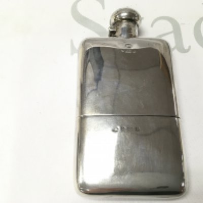 A silver Birmingham hallmarked hip flask. 196g 15x8cm Postage B