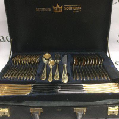 Three cased cutlery sets including a gold plated Solingen set. Shipping category D.