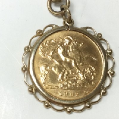1982 half sovereign in mount with 9ct gold chain. 20.10g total. Postage A