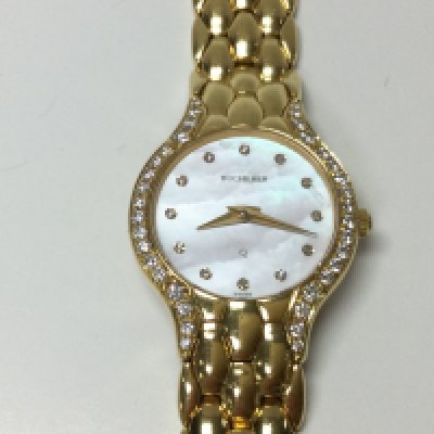 An 18ct gold Bucherer ladies watch. Mother of pearl dial with diamond markers and around case. Quartz movement. Seen running. 57.80g total weight. Postage B