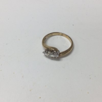 A 9ct gold three stone diamond ring. Approx weight 2.55 grams, size P.
