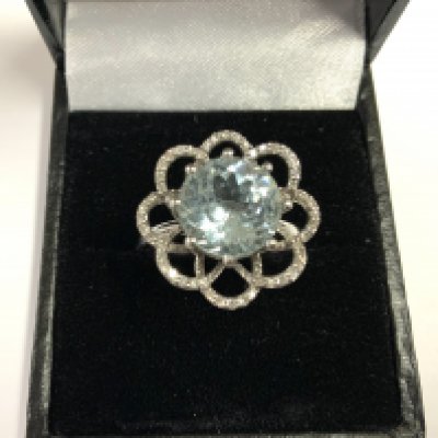 A white gold diamond and aquamarine ring in a floral design. 4.47g, Size P. (A)