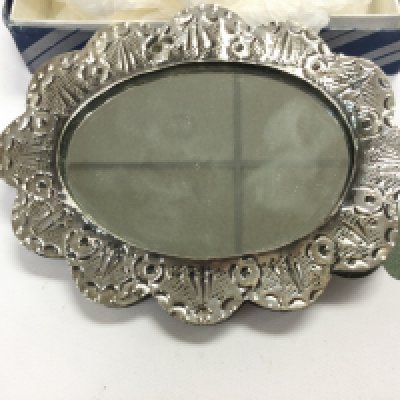 A small silver hand mirror possibly Persian. 13.5cm wide. NO RESERVE