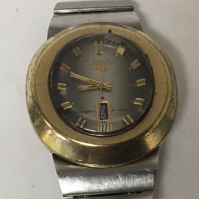 A rare Gents Vintage Seiko 5 wrist watch Automatic 21 Jewel with an oval brass vase and vertical day date serial number 441088 not seen working. NO RESERVE