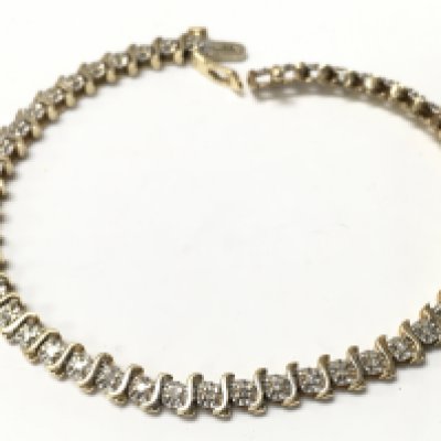 A 14k gold bracelet set with a row of small chip diamonds , total weight 10.2g. Postage category A