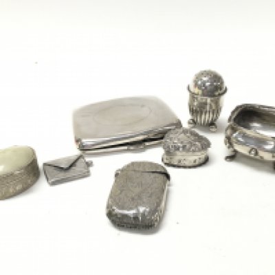 A group of silver hallmarked items including a stamp holder, pin boxes, a cigarette case etc. postage category B