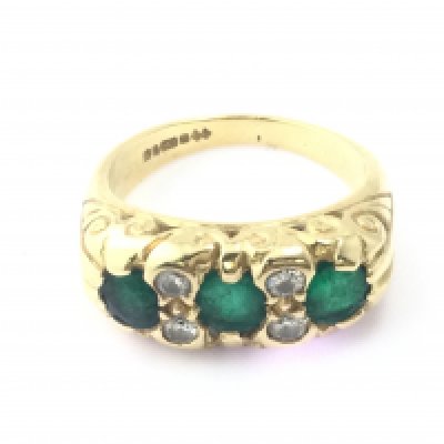 An 18ct emerald and diamond ring. Size M and 9.51g Postage A